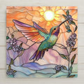 Handcrafted ceramic tile featuring a radiant hummingbird in stained glass style against a warm sunrise sky. A perfect bird lover gift or nature wall art.