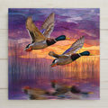 Stained glass style mallard duck ceramic tile with a pair of mallards landing on a deep cobalt and teal autumn pond, vivid emerald and amber plumage and russet autumn reeds, a vivid waterfowl and duck lover wall art gift.