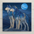 Stained glass-style wolf pair ceramic tile wall art showing two wolves standing together beneath a blue moon in a night forest scene. A permanent high-resolution ceramic print designed to resemble stained glass, not made of glass or mosaic. Ideal as an anniversary gift, couple wall decor, or symbolic home decor celebrating partnership. Optional wall hanger, easel stand, cork backing, and premium frame available.