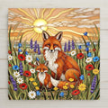 Stained glass style ceramic art tile of a mother fox and baby fox in a wildflower meadow of poppies daisies and lavender at sunset, woodland nursery and new mom baby shower decor.