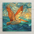 Stained glass–style pelican ceramic tile wall art featuring a soaring pelican above ocean waves and sunlit skies. A coastal-inspired piece perfect for wall decor or shelf display. Printed artwork on ceramic tile, not actual stained glass. Optional tile wall hanger, easel tile stand, cork backing, and premium frame available for versatile home decor display.