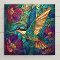 A vibrant hummingbird in flight among colorful flowers is featured in this stained glass-style ceramic tile wall art. Symbolizing joy, resilience, and renewal, this high-resolution ceramic print offers the look of stained glass while remaining durable and fade-resistant. A meaningful nature-inspired home decor piece. Optional cork backing, easel stand, tile wall hanger, and premium black frame are available.