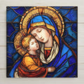 Madonna and Child stained glass style ceramic tile wall art featuring Virgin Mary holding baby Jesus in rich blue and gold tones.