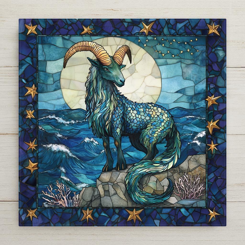 Stained glass style ceramic art tile of a Capricorn sea goat with a fish tail standing by the ocean under a full moon and stars with coral, celestial coastal zodiac astrology wall decor in teal and gold.