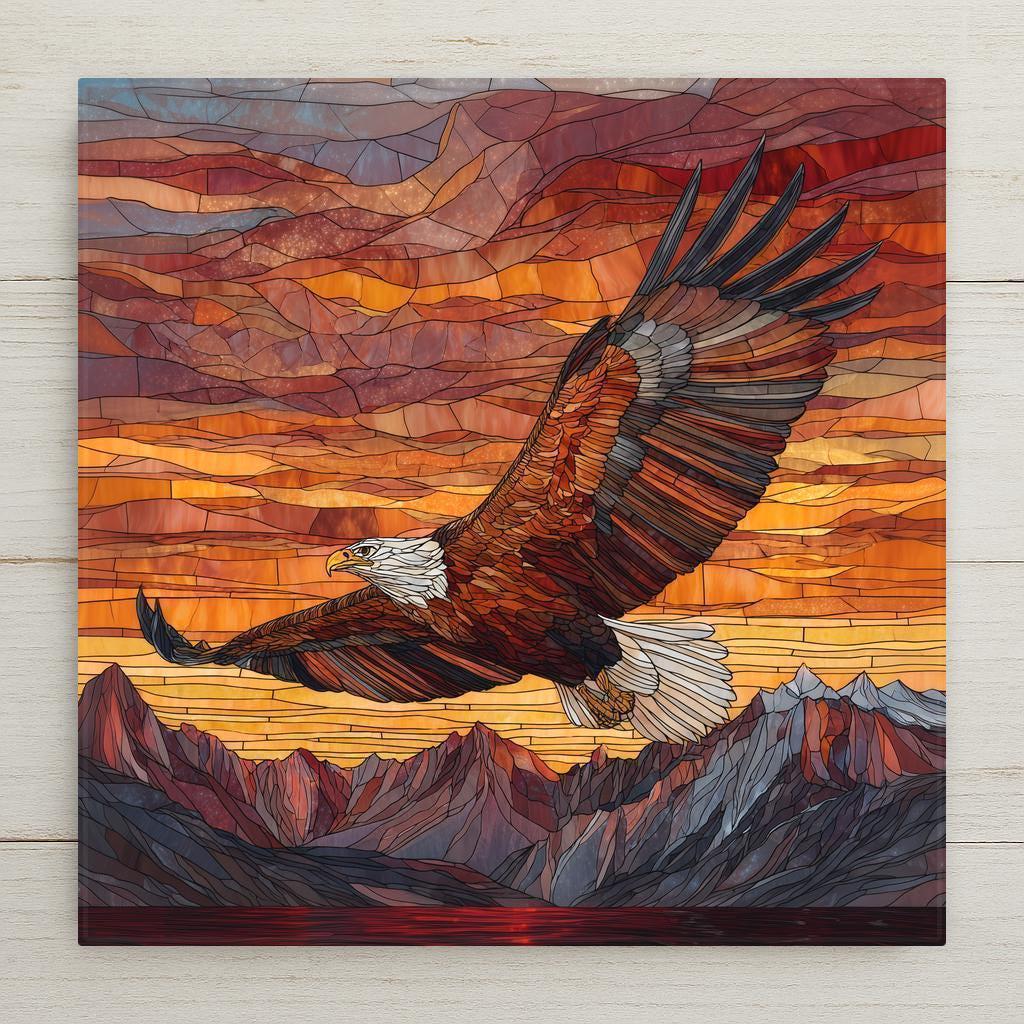 A stained glass–style ceramic tile featuring a soaring bald eagle above glowing sunset mountains in vivid amber, red, and gold tones.