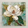 White magnolia stained glass–style ceramic tile wall art featuring ivory petals, soft green leaves, and warm gold accents. Botanical floral home decor with a calm, elegant look. Permanent ceramic print designed for indoor wall decor or tabletop display.