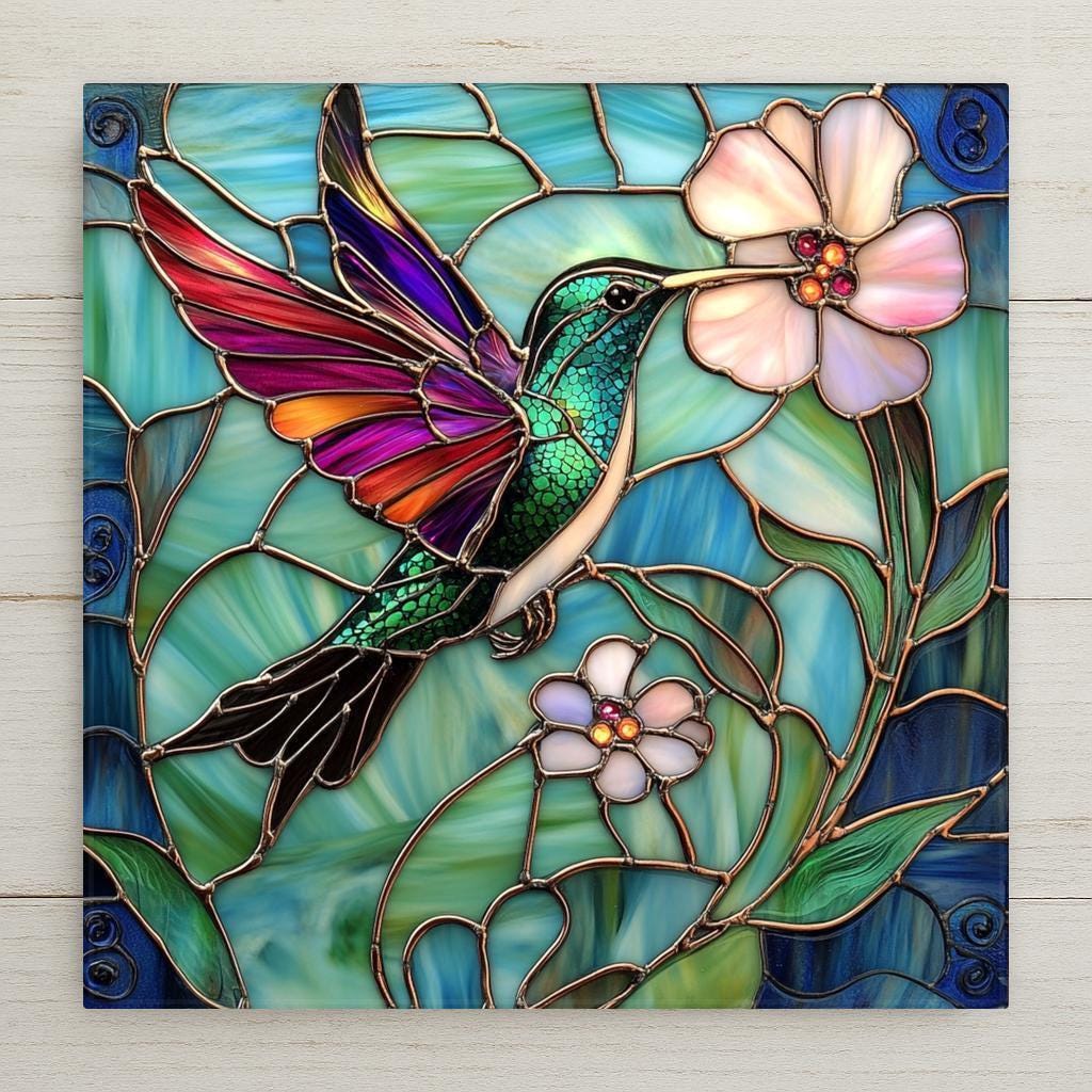 Handmade ceramic tile art featuring a vibrant hummingbird and floral motif in stained glass style. A bold and beautiful gift for spring or garden décor.