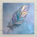 Feather ceramic tile wall decor showing a single flowing blue and teal feather in a stained glass–style design. Smooth ceramic tile with a permanent printed image, not real stained glass or mosaic.