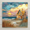 Stained glass style coastal cottage decorative tile showing a small beach house near the ocean at sunset, surrounded by tall grasses and soft rolling clouds. Printed on glossy porcelain, this seaside art tile features layered mosaic textures in blues, golds, and earth tones, creating a calm ocean-inspired wall decor piece suited for beach houses, cottages, or coastal home interiors.