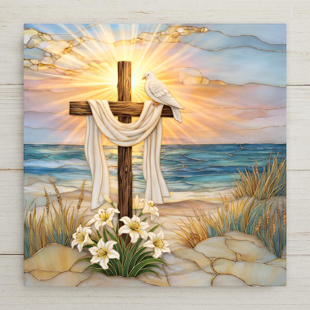 Stained glass style ceramic tile featuring a wooden cross draped in white cloth on a beach at sunrise. A white dove rests on the cross, with lilies blooming at the base and ocean waves behind. Christian wall art ceramic tile with coastal religious decor and faith home decor feel.