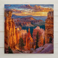 Bryce Canyon ceramic tile wall art featuring tall red rock hoodoos in Bryce Canyon National Park, Utah, shown in a stained glass style mosaic with warm orange sandstone tones and a glowing sky. Square desert landscape tile artwork suitable for wall or tabletop display with optional wall hanger, easel stand, cork backing, or premium frame.