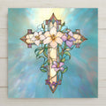 Stained glass style ceramic art tile showing an ornate cross framed by white Easter lilies and lavender blooms on a soft blue background, William Morris inspired Christian faith and sympathy wall decor.