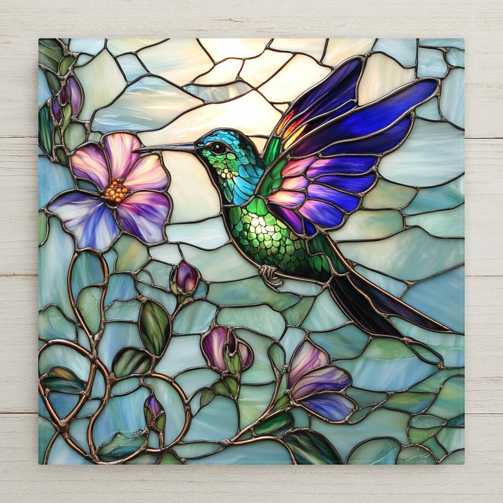 This ceramic tile shows a glowing green hummingbird sipping from purple flowers in stained glass style. A beautiful nature-themed handmade art gift.