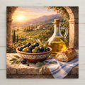 A Mediterranean-inspired ceramic tile featuring a hand-painted bowl filled with green and black olives, an elegant glass olive oil cruet, and rustic bread resting on a stone terrace overlooking sunlit Tuscan vineyards at sunset. Warm golden light bathes rolling hills, cypress trees, and a countryside villa, creating Italian kitchen wall decor with Mediterranean home decor charm.