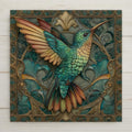 Art Nouveau hummingbird ceramic tile featuring a teal and gold hummingbird with outstretched wings surrounded by ornate botanical leaves and flowing floral patterns. Square nature-inspired wall decor with detailed linework and a vintage botanical illustration style.