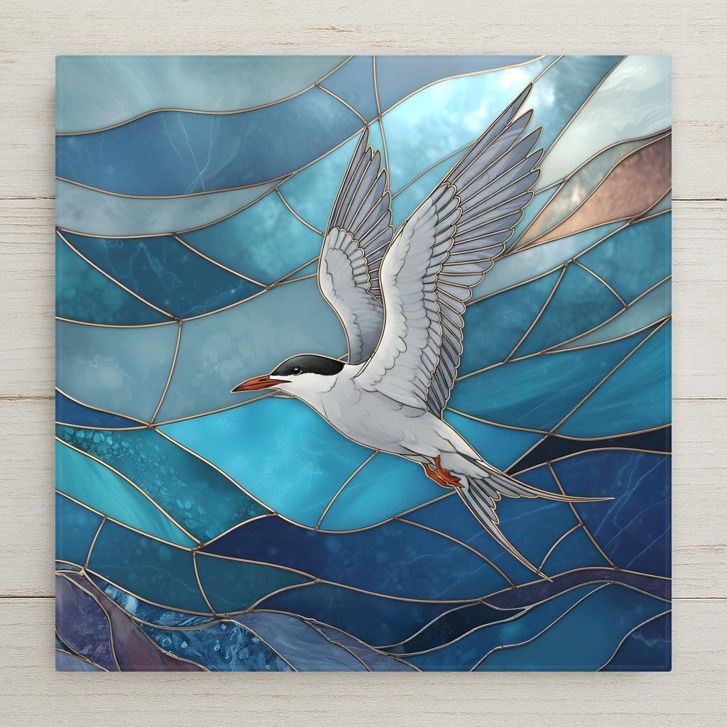 White tern with black cap and red beak in flight over layered turquoise and deep blue ocean waves in stained glass style, coastal ceramic tile wall art.