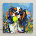 Colorful painterly ceramic art tile of a tricolor Cavalier King Charles Spaniel holding a tennis ball among bright flowers, playful dog oil painting style pet decor.