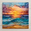 Stained glass style ocean sunset decorative tile featuring layered blue and turquoise waves beneath a glowing golden sun on the horizon. Printed on glossy ceramic, this coastal art tile shows flowing mosaic textures, warm shoreline tones, and soft sunset clouds, creating a calming beach house wall decor piece inspired by sea and sky.