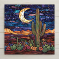 Stained glass style ceramic art tile of a saguaro cactus beneath a glowing crescent moon and starry night sky, with blooming prickly pear and desert flowers below and layered mesas behind, in marbled southwestern desert colors.