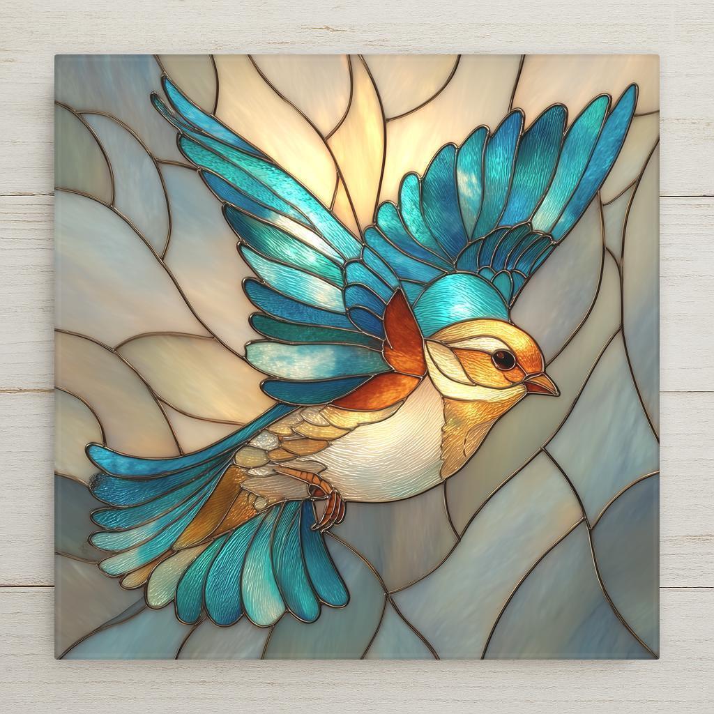 Stained glass style ceramic art tile of a blue and teal songbird in flight with amber accents on a soft cream leaded glass background, elegant teal bird wall decor for nature and bird lovers.