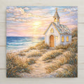 A coastal chapel wall art ceramic tile showing a small seaside church set among sand dunes at sunset. A winding sandy path leads to the chapel, with ocean waves, soft clouds, and warm evening light creating a calm coastal wall art scene. Stained glass–inspired permanent print on ceramic tile. Optional wall hanger, easel stand, cork backing, and premium frame available.