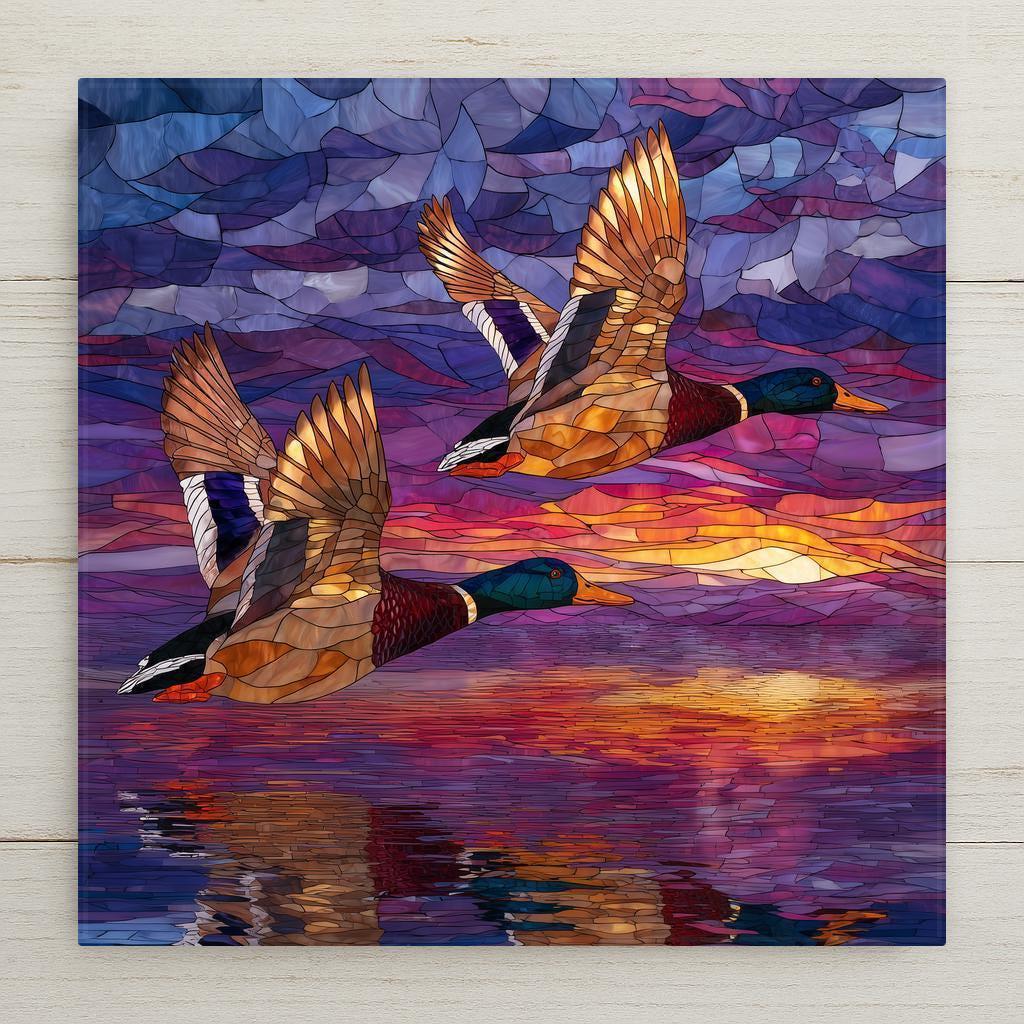 Flying ducks ceramic tile wall art featuring two mallard ducks in a stained glass–style sunset scene over reflective water. Nature-inspired wildlife decor with warm sunset colors. A meaningful home decor gift with optional wall hanger, easel stand, cork backing, or premium frame for display.
