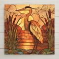 Golden heron stained glass-style ceramic tile with amber, mocha, and olive tones. Perfect wall art for home decor. Optional tile wall hanger, tile stand, cork backing, and premium frame available. Permanent print on tile, not real stained glass or mosaic.