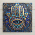 Stained glass style hamsa hand ceramic tile showing an ornate gold-lined hamsa with a large evil eye in the palm against radiating jewel-blue mandala glass panels, boho protection wall art