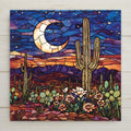 Moonlit desert ceramic tile with glowing crescent moon, vibrant cacti, and colorful wildflowers in stained glass style. A bold, Southwest-inspired wall art piece perfect for rustic homes or handmade gift giving.