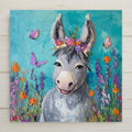 This Smiling Donkey Ceramic Tile features a flower-crowned gray donkey surrounded by butterflies and florals. Perfect for spring or farm decor. Optional tile wall hanger, cork backing, or stand available.