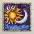 Sun and moon ceramic tile in stained glass style. Features celestial faces, glowing gold and moonlight tones. A cosmic gift for home décor lovers.