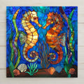 This seahorse stained glass style ceramic tile wall art glows with ocean blues, golds, and amber tones. Perfect for beach houses or nautical décor, it includes optional add-ons like a tile wall hanger, easel tile stand, or cork backing. A stunning gift for ocean lovers.