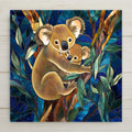 Stained glass style ceramic art tile of a mother koala and baby koala in a eucalyptus tree on a deep navy blue leaded glass background, australian wildlife nursery wall decor.