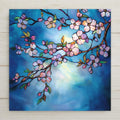 Stained glass style cherry blossom ceramic tile with a luminous branch of pale pink and rose sakura blossoms against a deep cobalt and teal misty dawn sky, warm gold light through falling petals, a vivid Japanese sakura and spring floral lover gift.