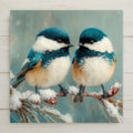 Chickadee ceramic tile wall art showing two chickadees with fluffy winter plumage perched on snow-covered pine branch in winter woodland with soft blue-white snow and warm cabin feeling