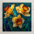 Daffodil ceramic tile wall art in stained glass style showing trumpet-shaped daffodil blooms with jewel tones of gold and cream with luminous lead line segmentation against spring green