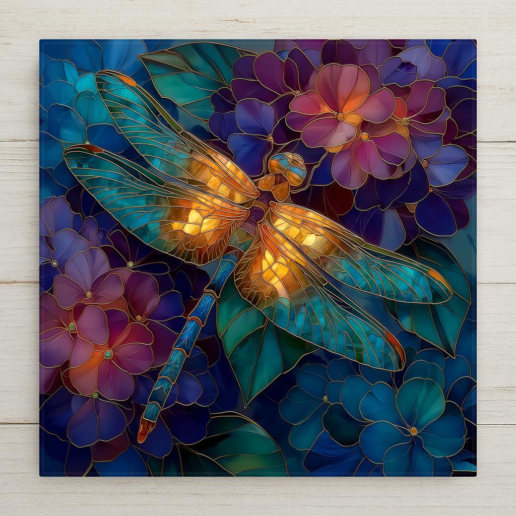 Stained glass style ceramic tile of a golden amber dragonfly with glowing orange-red wings resting on a dense field of blue, purple, and blush-mauve hydrangea florets, outlined throughout in luminous copper and gold leaded lines.