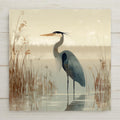 Great blue heron ceramic art tile standing in a marsh with reeds in soft blue grey, sage and cream.