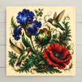 Two hummingbirds and three jewel-tone blooms ceramic art tile among emerald foliage on cream, vintage botanical.