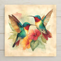 Vivid watercolor ceramic art tile featuring two hummingbirds in mid-flight near vibrant tropical flowers, the pair facing each other in tender mirrored composition with jewel-toned feathers in emerald green, ruby red, sapphire blue, and golden amber. Romantic anniversary couples decor with optional tile wall hanger, easel stand, cork backing, or premium frame.