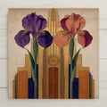 Authentic 1920s Art Deco poster style ceramic art tile featuring two iris flowers in mirrored symmetrical composition with central medallion against geometric ziggurat background and gold leaf metallics in Roaring 20s deep purple, brass gold, oxblood, copper, and deep amber palette. Tender anniversary couples decor with optional tile wall hanger, easel stand, cork backing, or premium frame.