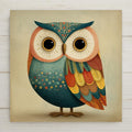 Sweet folk art ceramic art tile featuring a baby owl with oversized expressive eyes and plump downy form rendered in primitive folk style with gentle decorative patterns in soft cottagecore palette of dusty pink, cream, sage green, butter yellow, soft mint, and gentle brown. Nursery baby shower gift decor with optional tile wall hanger, easel stand, cork backing, or display frame.