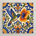 Talavera hummingbird ceramic tile wall art with a blue and green hummingbird feeding at an orange folk art flower, cobalt scrollwork on cream, Mexican folk art kitchen decor