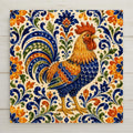 Hand-painted Talavera style ceramic art tile of a colorful rooster in cobalt blue, orange, and gold surrounded by dense Mexican folk art scrollwork on a cream background.