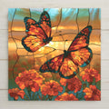 Stained glass style ceramic tile of two monarch butterflies flying over a field of bright orange marigolds in warm golden light