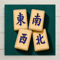 Four mah jongg wind tiles east south west north with deep blue lapis characters set in gold on ivory faces resting on teal felt on a square ceramic art tile