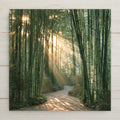 Stained glass style ceramic art tile of a sunlit bamboo grove, golden sunbeams streaming between tall green glass bamboo stalks above a winding stone path.