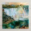Niagara Falls ceramic art tile in an alcohol ink style — teal and aquamarine water pouring over the falls, a rainbow arcing through the rising mist above gold-veined rock.