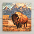 Stained glass style ceramic art tile of an American bison in golden autumn grass beneath the Grand Teton mountain range, steam at its muzzle and yellow aspens at the treeline.