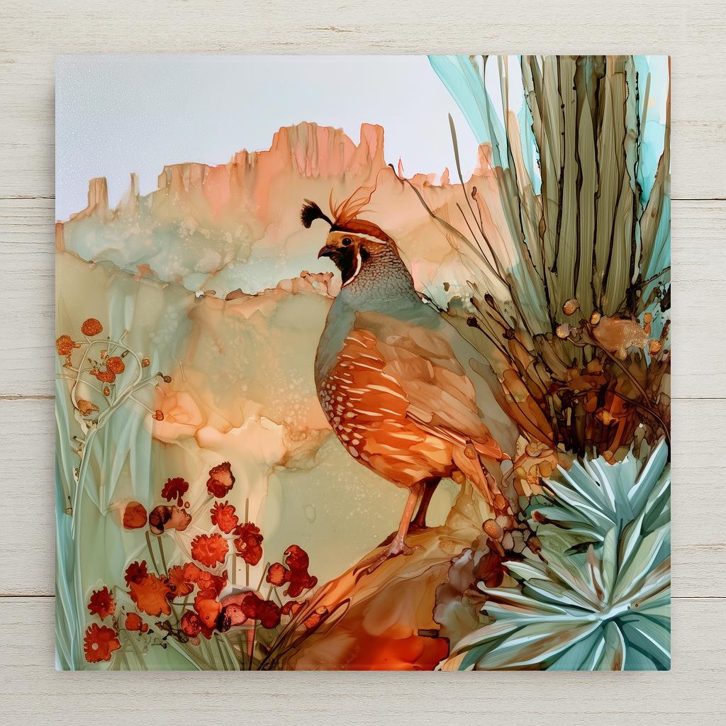 Alcohol ink style ceramic art tile of a Gambel's quail with its black teardrop plume perched on red rock, blue agave and a cactus trunk beside it, red desert blooms below and salmon-colored cliffs behind under a pale sky